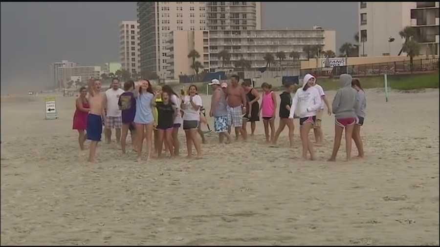 A woman whose car was stuck in some soft sand along Daytona Beach was helped by a Christian youth group's muscle power, and perhaps a higher power.