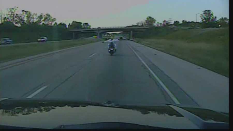 Police dash cam video from Bayside shows a woman driving a motorcycle on Interstate 43 with no hands... and no shirt!