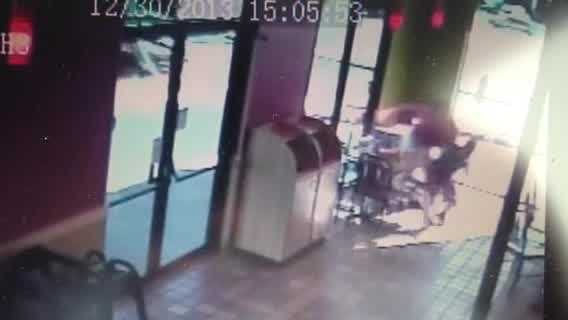 A woman and a child run from an SUV that crashes into a Popeye's restaurant.