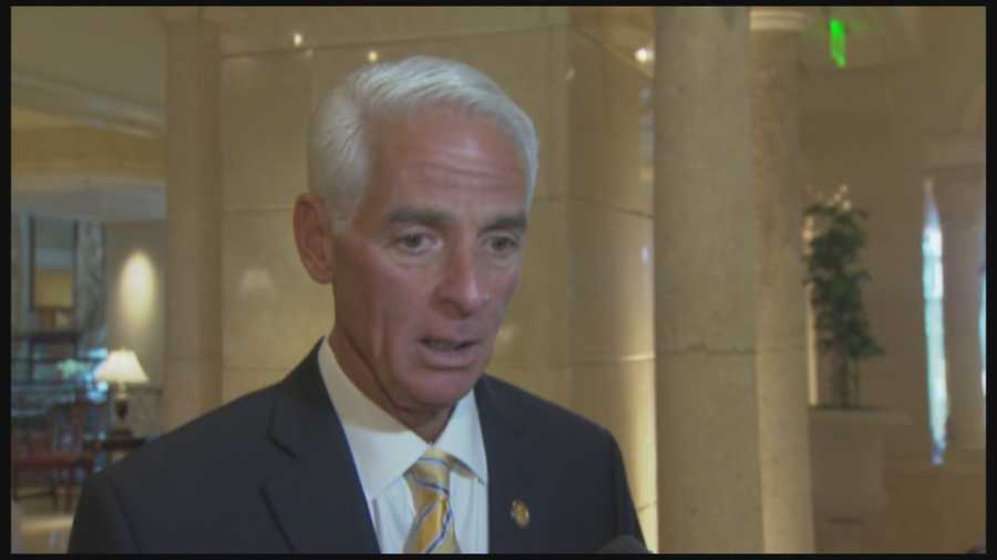 Former Gov. Charlie Crist is blaming Republican Gov. Rick Scott for being uninvited to speak at the Council of 100 policy advisory group's meeting.