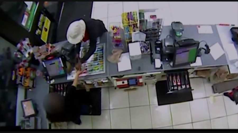 A man wearing a trench coat is on the run this morning after grabbing a 7-Eleven clerk by the neck and robbing the store, investigators said.