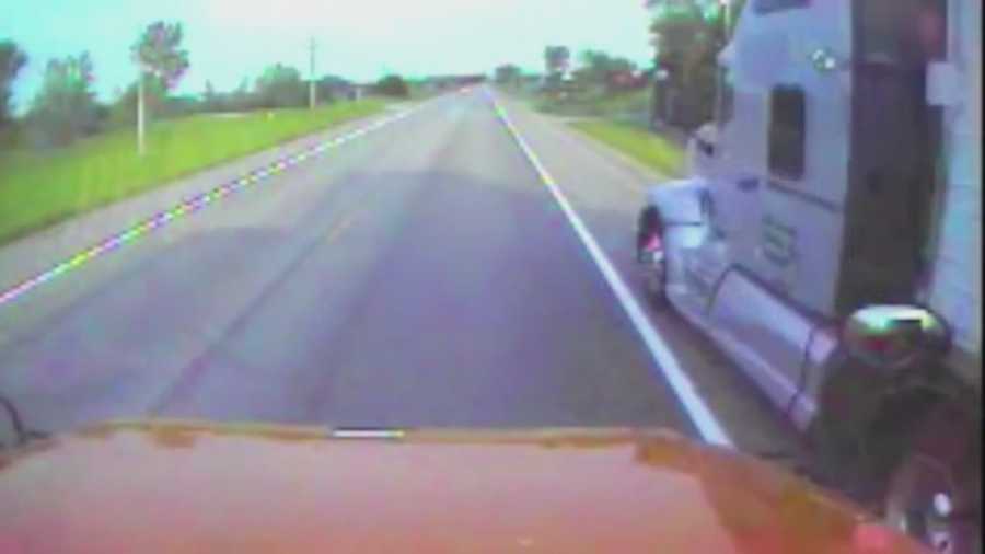 A tractor-trailer is caught on bus video as it speeds passed the stopped school bus. The school bus, that had its flashing lights on and safety arm out, was allowing a student to get off at a stop.