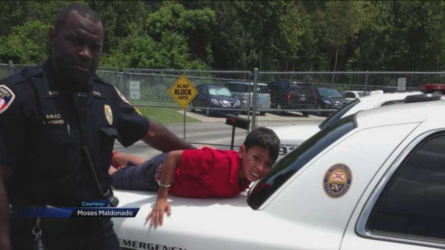 A photo showing a 10-year-old boy with autism handcuffed and propped up on the back of a Kissimmee police cruiser is making the rounds on social media.