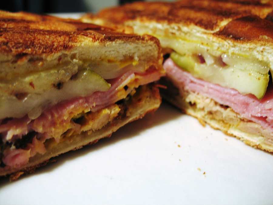 5. Cuban Sandwich The Cuban Sandwich is made with ham, roasted park, Swiss cheese, pickles, mustard and sometimes salami on Cuban bread. It became a popular Florida delicacy in the 1960s when there was an influx of Cuban immigrants. The sandwich was designated as the