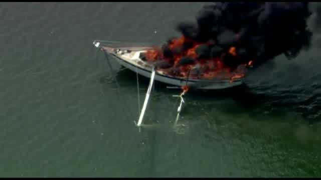Chopper 2 video shows a boat engulfed in flames Friday afternoon in Brevard County. Two people and two pets were rescued.