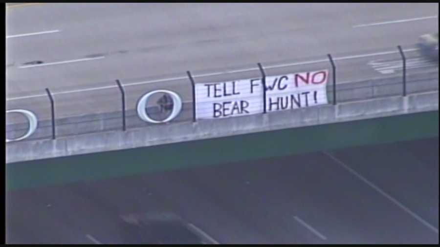 Bear hunting opponents caught the attention of Orlando drivers with a sign above Interstate 4 on Monday.
