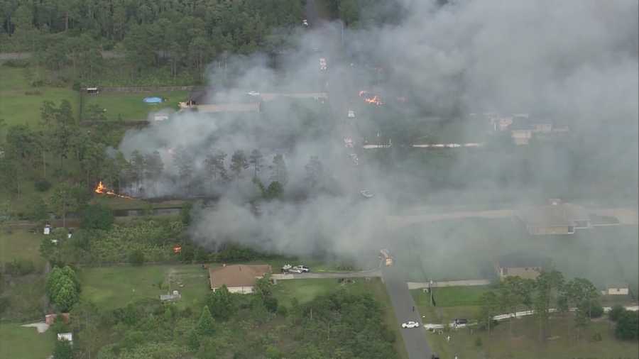 Firefighters battled a 10-acre brush fire near homes in east Orange County on Tuesday.