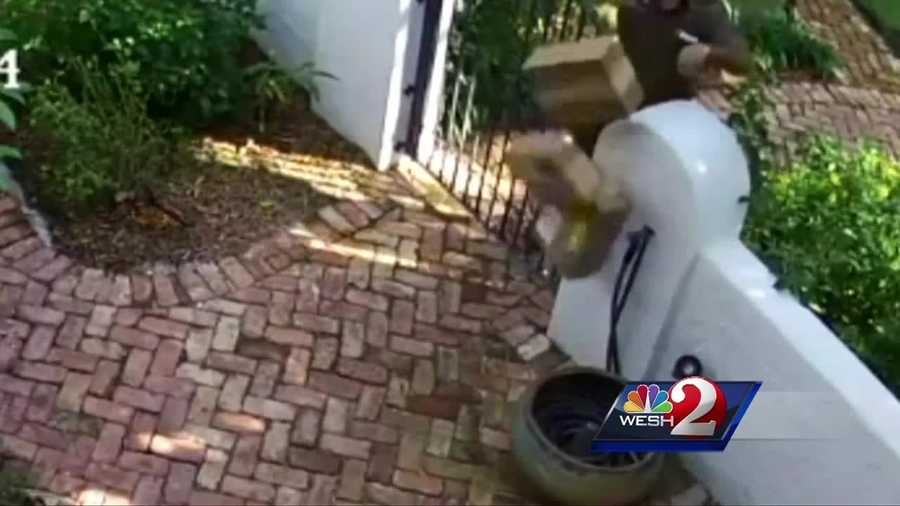 A UPS driver was caught on a home security camera carelessly tossing packages over a fence, causing the contents to spill.