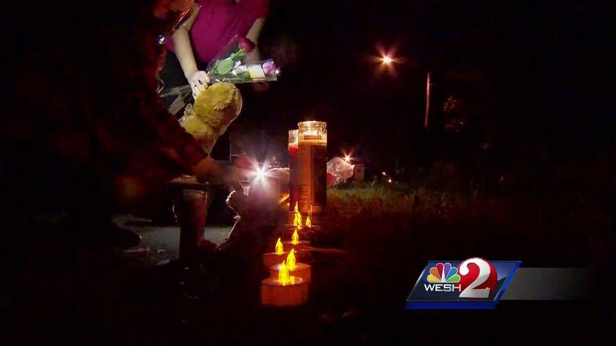 Loved ones remembered the lives of a slain mother and daughter this weekend by lining the curb of their Pine Hills home with candles, teddy bears and roses.