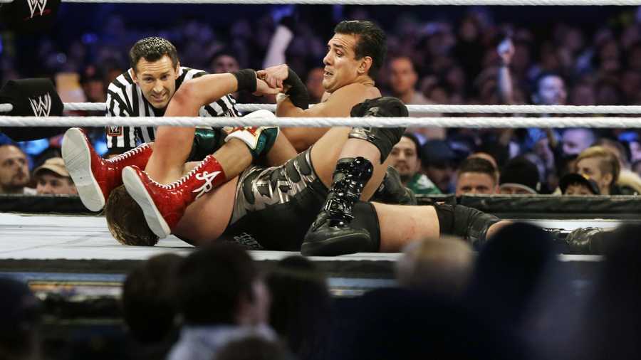 Jose Alberto Rodríguez, top, of Mexico, known as Alberto Del Rio wrestles Jacob "Jake" Hager, Jr., known as Jack Swagger, Sunday, April 7, 2013, in East Rutherford, N.J., during the WWE Wrestlemania 29 event. 