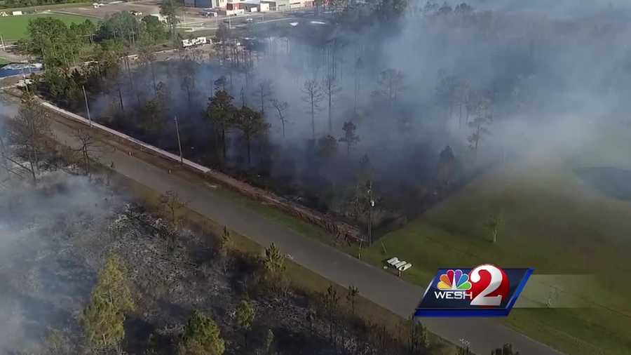 Firefighters have knocked down a brush fire that burned approximately 20 acres in a residential area of eastern Orange County, fire officials say.