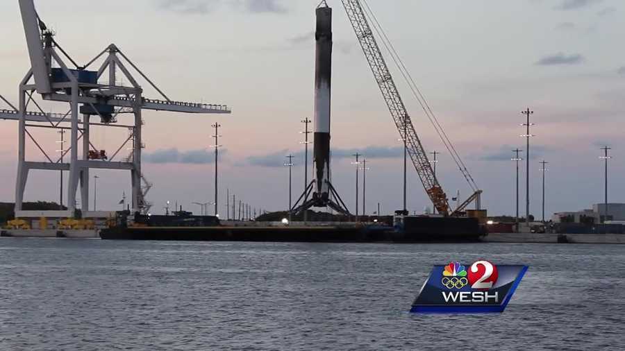 SpaceX's fourth recovered rocket is back at Cape Canaveral leaning to one side but still standing tall on its ocean platform.