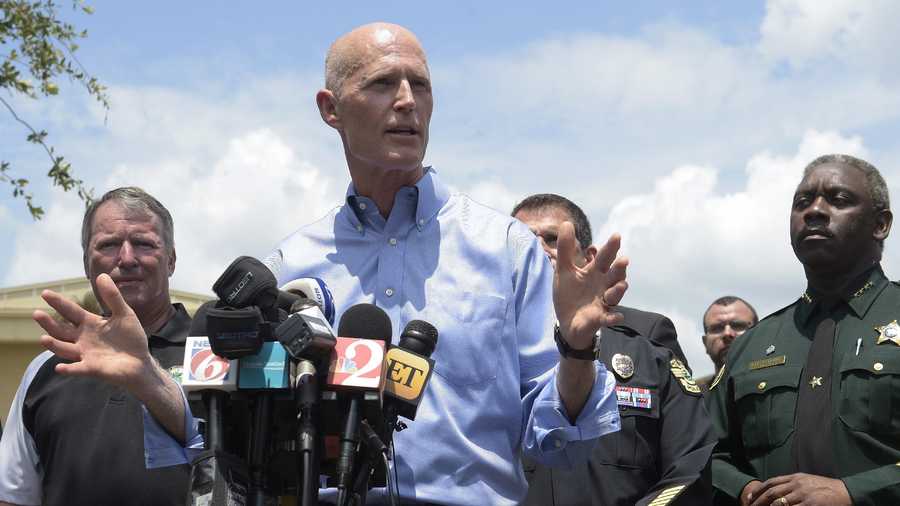 Florida Gov. Rick Scott, center, addresses reporters during a news conference after the Pulse nightclub shooting.