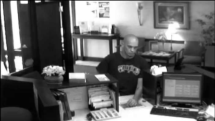 Police released this surveillance photo of the man accused in the bank robbery.