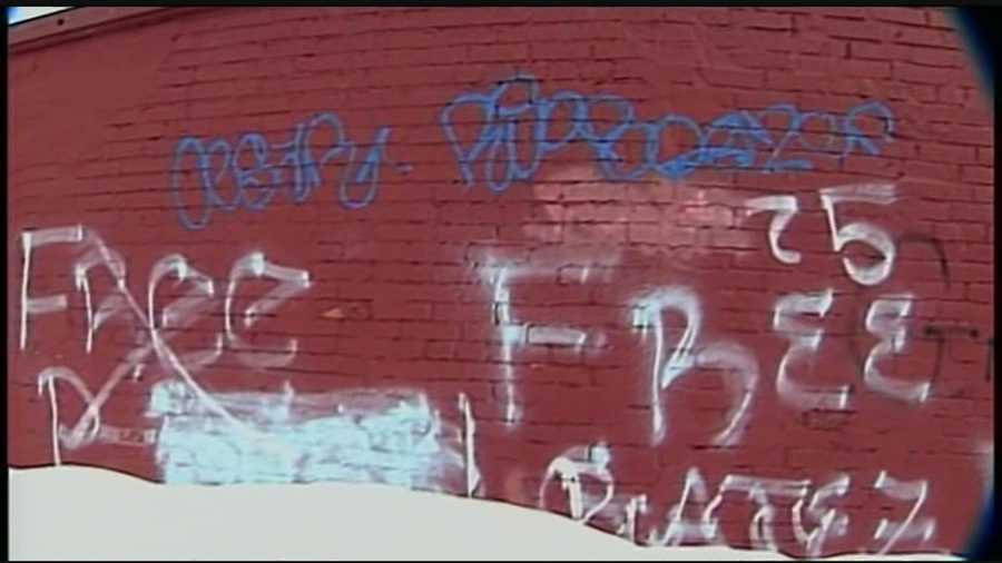 A blue streak of graffiti and other tags wrap around an office on N. Pitt Street in Carlisle, Pa.