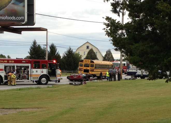 Woman dies in crash involving school bus along Route 30