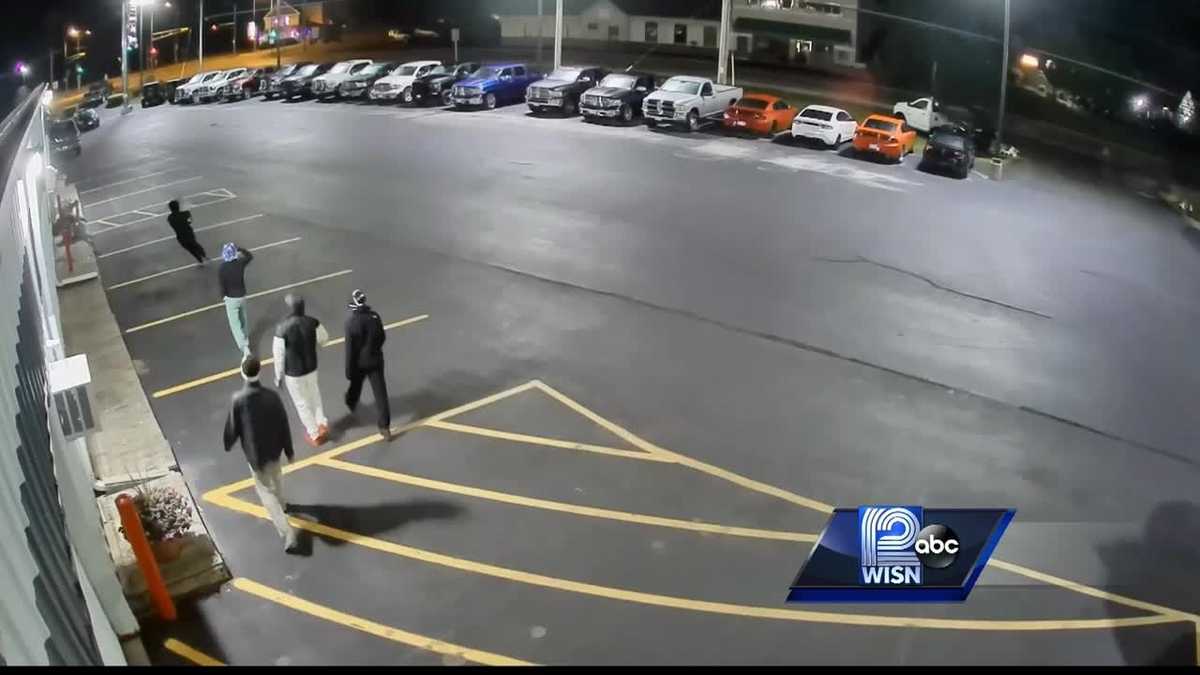 Surveillance video shows people breaking into car dealership
