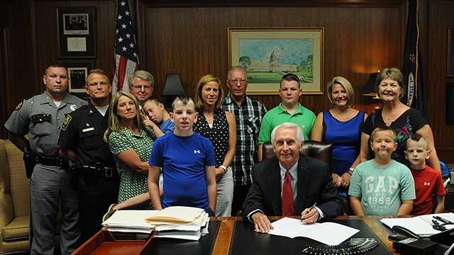 June 25, 2014: Gov. Steve Beshear signs a bill during a private ceremony with Ellis' family renaming a stretch of the Bluegrass Parkway in Bardstown in honor of Ellis.