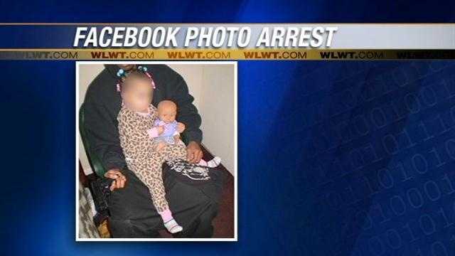 A man is being held on $2,000 bond after he was accused of posting a photo on Facebook that showed him with a baby and a gun.