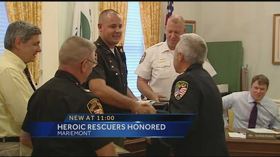 Two members of law enforcement were honored Monday evening for helping to save a person in a heroic river rescue.