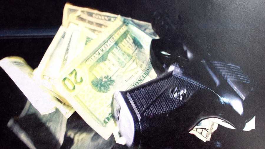 The gun and some cash found in car. The gun turned out to be an Airsoft pistol.