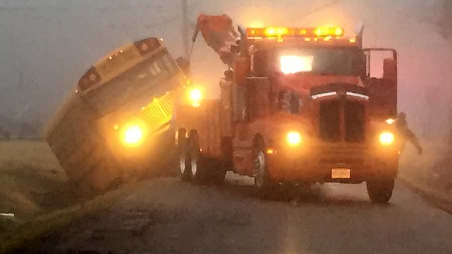 Tow truck works to pull bus out of ditch in Warren County
