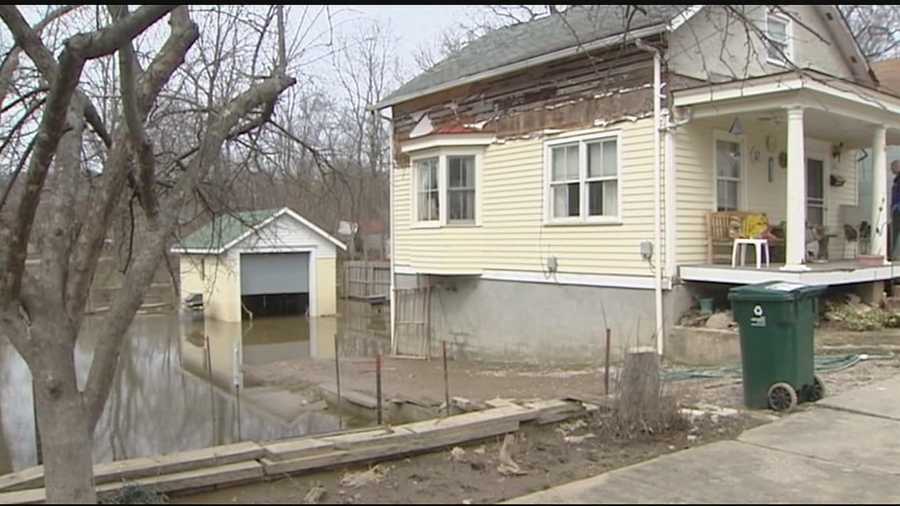 The river is below flood level, but mud is keeping it messy for homeowners along the river.