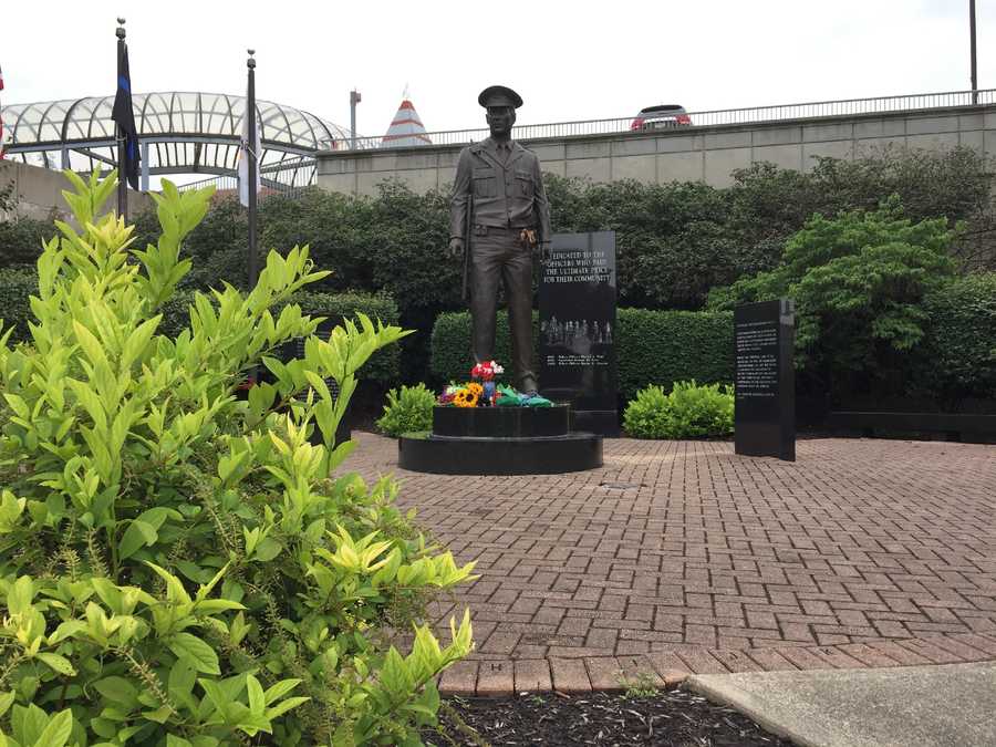 POLICE MEMORIAL2.jpg Community members leave flowers in Kim's honor at the Greater Cincinnati Police Memorial across the street from District 1 Headquarters.