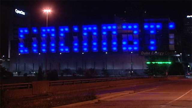 blue cincinnati sign for kim The Cincinnati sign on the west side of the Duke Energy Convention Center was turned blue with a black bar through it to symbolize the black bunting officers wear on their badges. It is a sign of mourning Kim.Read this story
