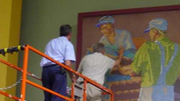 Art Conservators examining the murals at CVG in 2013, Via the Cincinnati Preservation Association 