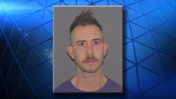 Justin Kuss, 38, is accused of threatening a woman with an ax.