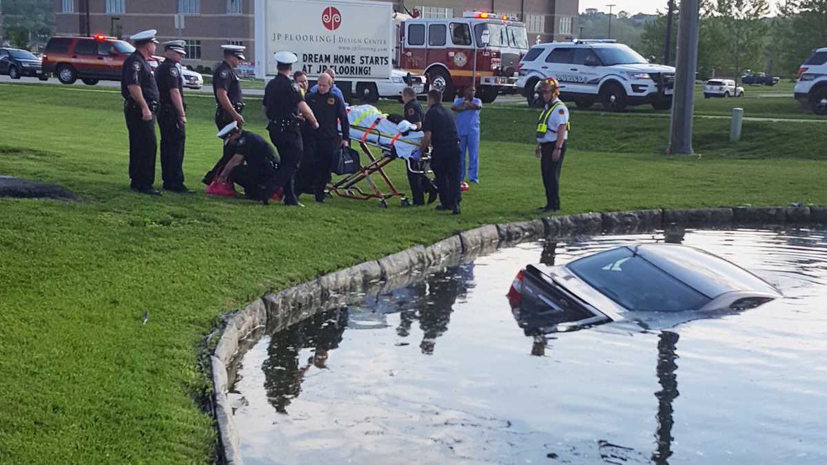 Photos: Man rescues woman from car in pond