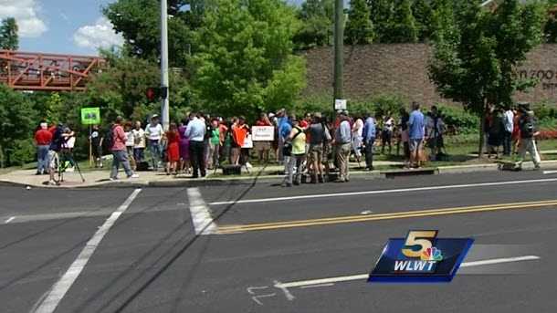 Community members gathered outside the Cincinnati Zoo May 30, 2016 after a gorilla was shot and killed to protect a boy who had gotten into his habitat.