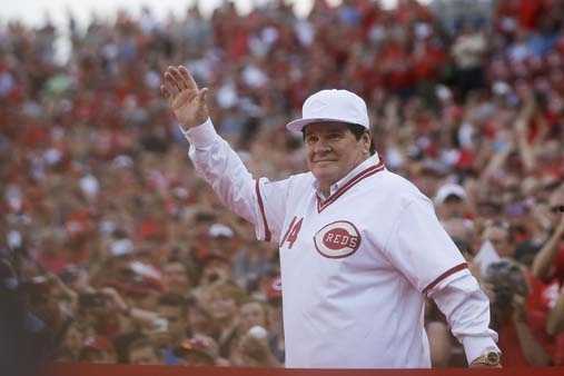 Former Cincinnati Reds player Pete Rose (14) is hugged by teammate Tony  Perez, center, as he is introduced during a ceremony to honor the 1976  World Series champions, before the Reds' baseball