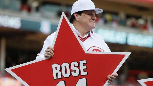 Former Cincinnati Reds player Pete Rose (14) is hugged by teammate Tony  Perez, center, as he is introduced during a ceremony to honor the 1976  World Series champions, before the Reds' baseball