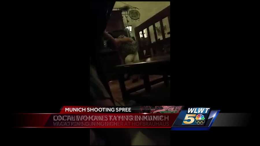A terrifying video shows a Mariemont woman diving under a table after hearing pops in a restaurant Friday in Munich, where authorities said a terror attack may have been carried out.