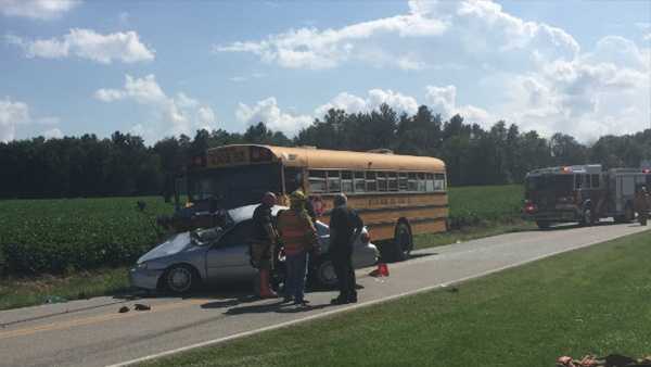 One person airlifted to hospital after crash involving car, school bus