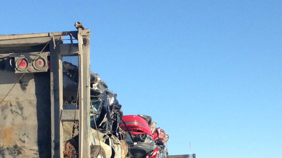 Photos Crushed cars fall off truck on busy highway