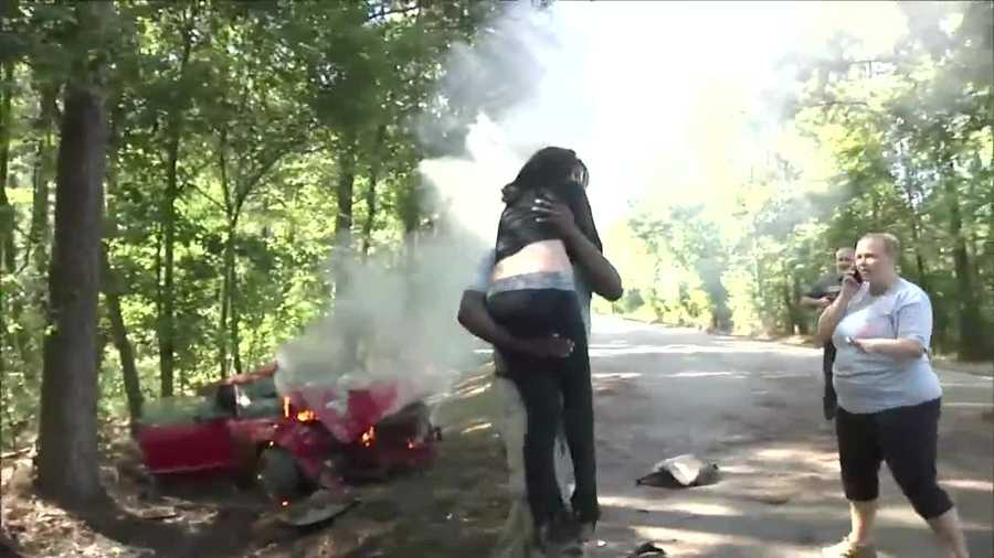 A TV news photographer from Louisiana rescued a woman from her burning vehicle on Tuesday.
