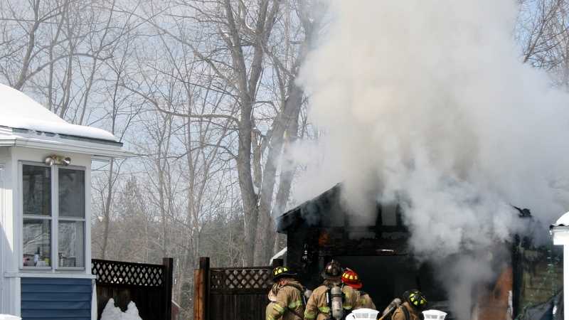 Photos: Fire destroys garage and injures man in Rochester