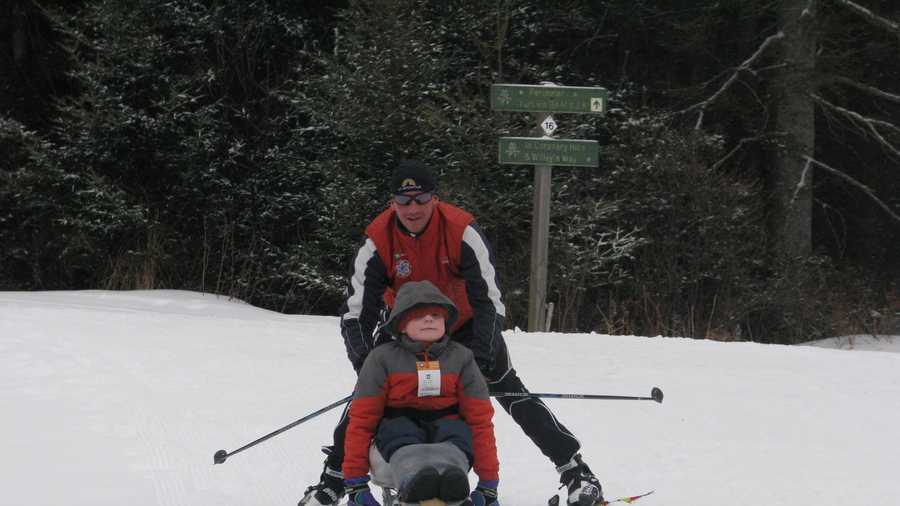 Lewis Bellows, 9, of East Kingston learns how to cross country ski in a sit ski with  instructor Patrik Viljanen, adaptive program manager for the New England Nordic Ski Association at Bretton Woods.