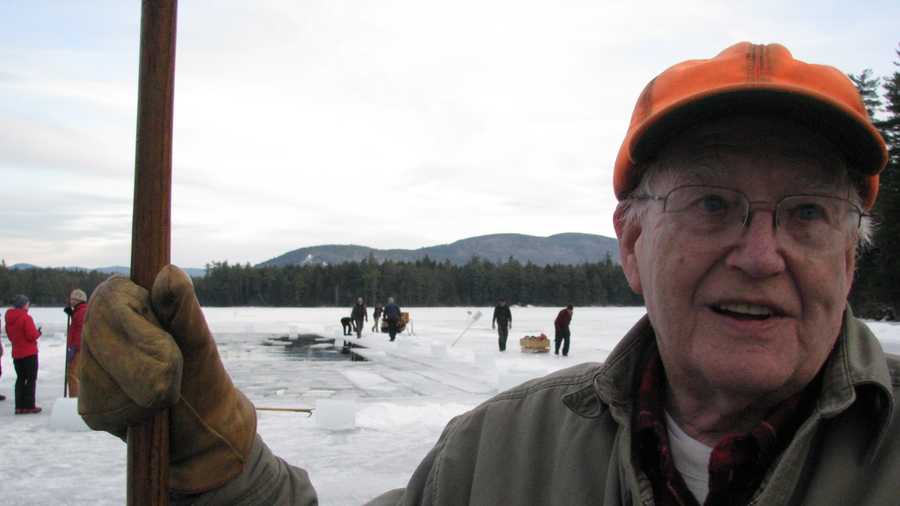 Norman Lyford, 87, of Ashland, holding a pike pole which hooks blocks of cut lake ice and directs it into the channel to be removed from the lake and stored in an ice house. On Monday, Norm stood for over eight hours on the ice in his 69th year cutting on Big Squam Lake for ice boxes at the rustic Rockywold Deephaven Camps.