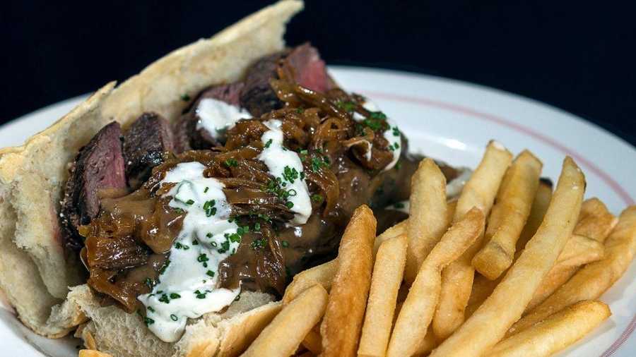 Tenderloin Sandwich - Open faced tenderloin sandwich on a home baked roll, smothered with onions and gravy
