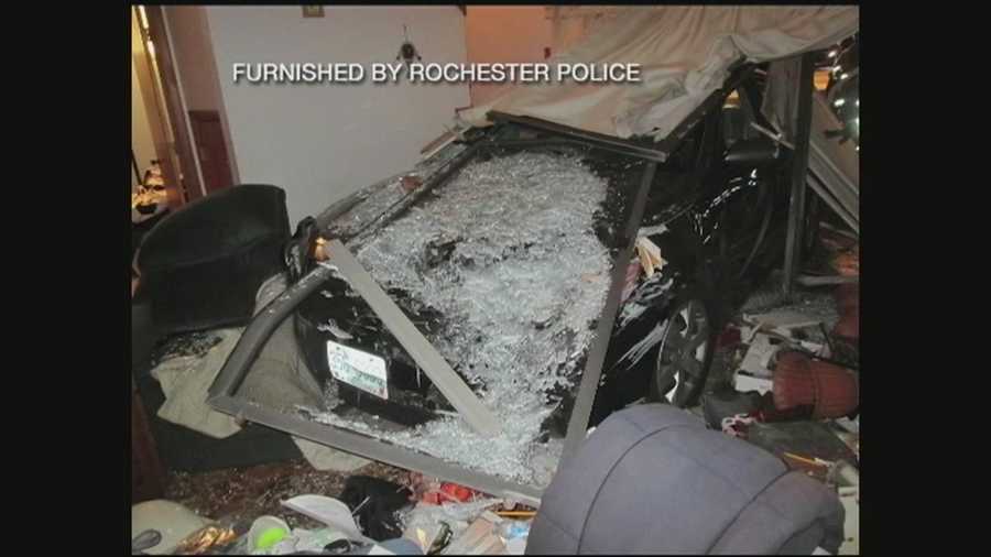 A Rochester home was damaged when a car crashed through a fence and a sliding glass door Wednesday night.