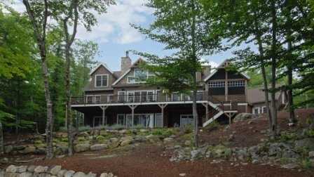 It sleeps 12. It has four bedrooms, six bathrooms, and is located at 27 South Winds Road in Moultonborough.