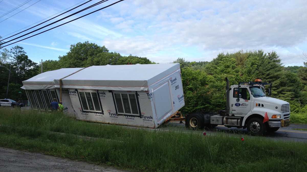 Trailer hauling modular home tips over in Claremont