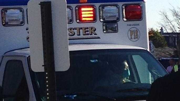 The driver of an ambulance carrying a man with Ebola-like systems is wearing a face mask and hazmat suit.