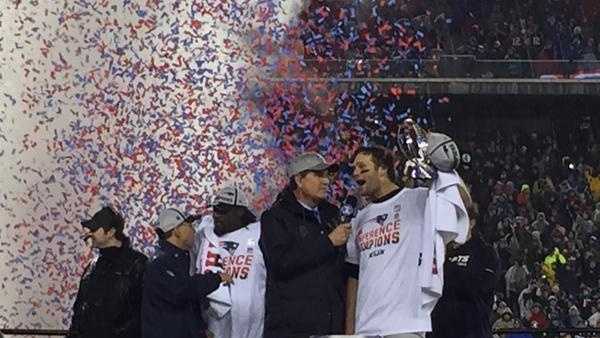 Tom Brady holds the AFC Championship trophy