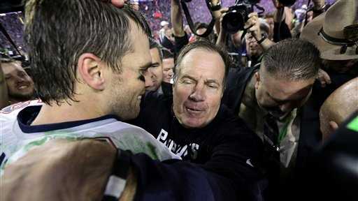 New England Patriots quarterback Tom Brady (12) and head coach Bill Belichick embrace.