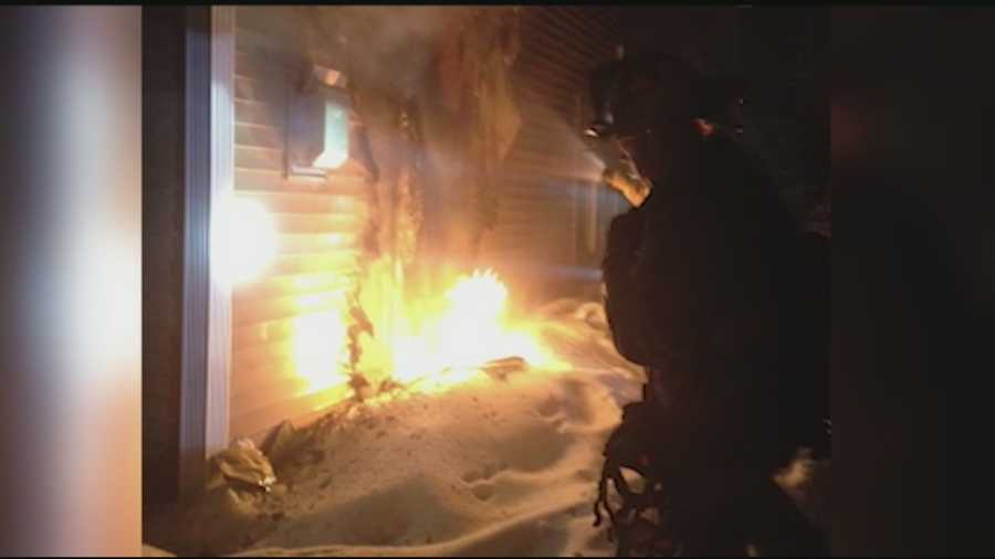 A police officer is being called a hero for helping a disabled man get out of a Portsmouth condominium that was on fire as firefighters reached into the flames to stop a propane leak.